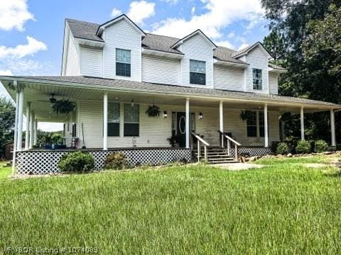 farmhouse inspired home featuring a porch and a front lawn