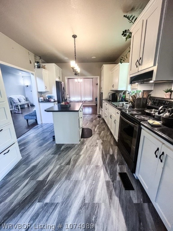 kitchen with white cabinetry, electric range, sink, and hanging light fixtures