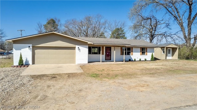 ranch-style home featuring brick siding, an attached garage, and driveway