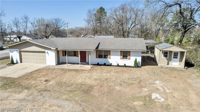 single story home featuring concrete driveway, brick siding, a garage, and a shingled roof