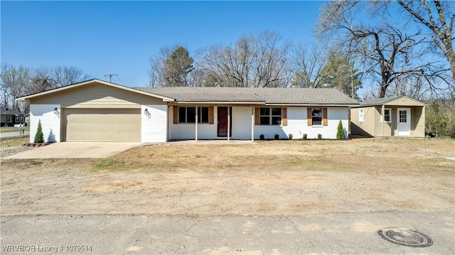 ranch-style home with brick siding, concrete driveway, and a garage