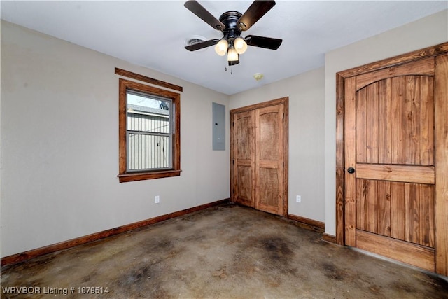 unfurnished bedroom with concrete floors, ceiling fan, baseboards, electric panel, and a closet