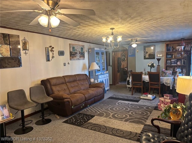 living room with carpet flooring, a textured ceiling, and ceiling fan with notable chandelier