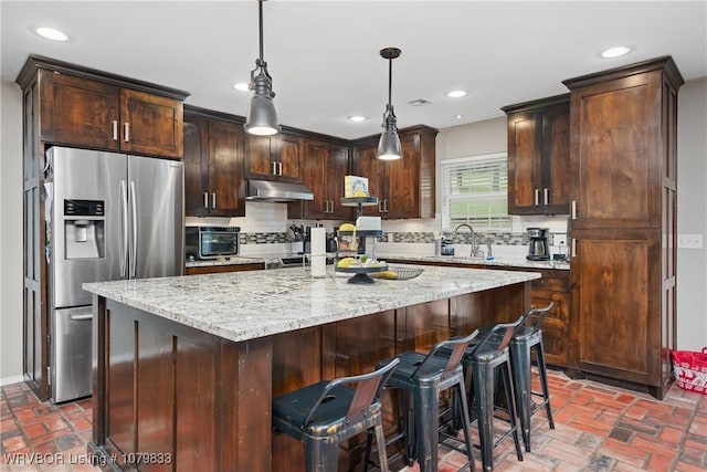298 Bayou Rd, Fort Gibson, OK 74434 - kitchen featuring decorative backsplash, light stone countertops, under cabinet range hood, brick floor, and stainless steel fridge with ice dispenser