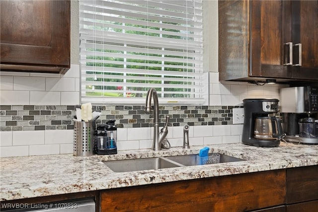 298 Bayou Rd, Fort Gibson, OK 74434 - kitchen featuring a sink, dark brown cabinetry, tasteful backsplash, and light stone counters