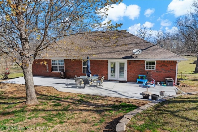 298 Bayou Rd, Fort Gibson, OK 74434 - back of property featuring brick siding, a lawn, and a patio area