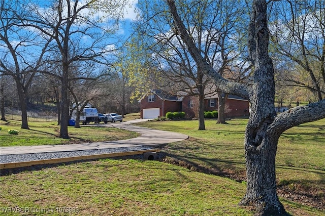 298 Bayou Rd, Fort Gibson, OK 74434 - view of yard featuring a garage and concrete driveway