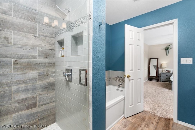 298 Bayou Rd, Fort Gibson, OK 74434 - bathroom featuring a tile shower, a garden tub, and wood finished floors