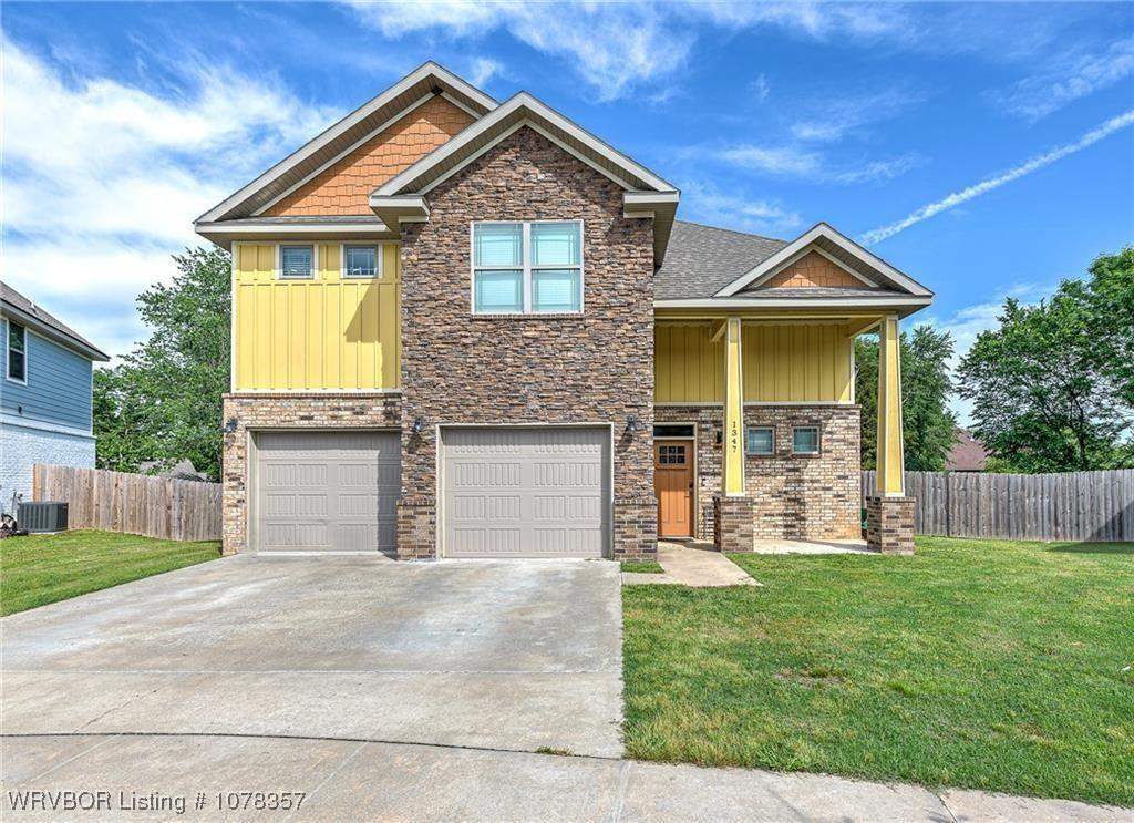 craftsman house with cooling unit, a front yard, and a garage