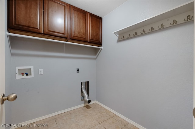 laundry area featuring baseboards, hookup for a washing machine, light tile patterned flooring, cabinet space, and electric dryer hookup