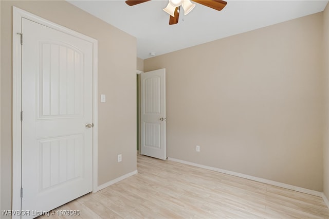 unfurnished bedroom with baseboards, light wood-type flooring, and ceiling fan