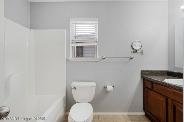 bathroom with baseboards, toilet, bathtub / shower combination, tile patterned floors, and vanity