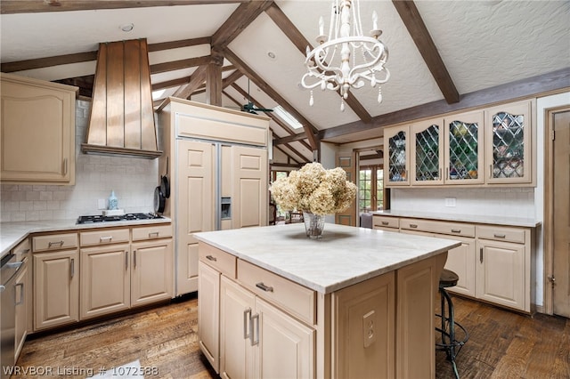 kitchen featuring decorative backsplash, wood-type flooring, decorative light fixtures, an inviting chandelier, and a kitchen island