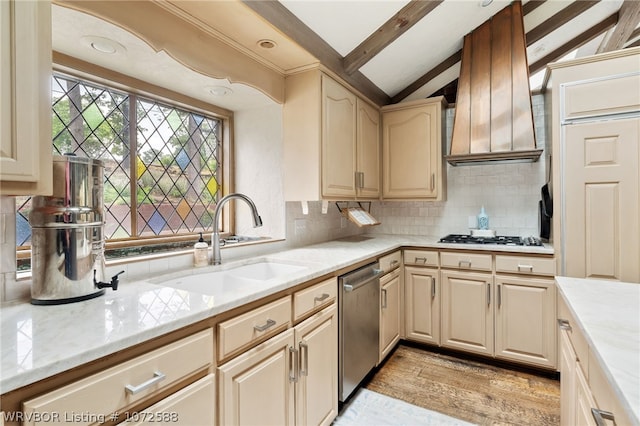 kitchen with sink, vaulted ceiling with beams, decorative backsplash, light hardwood / wood-style floors, and stainless steel appliances