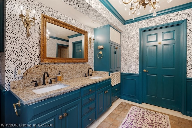 bathroom featuring tile patterned flooring, vanity, crown molding, and an inviting chandelier