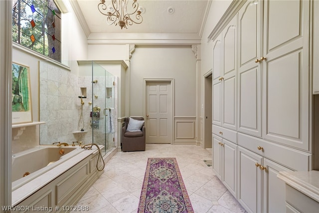 bathroom with ornamental molding and independent shower and bath