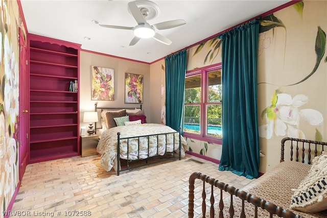 bedroom with ceiling fan and crown molding