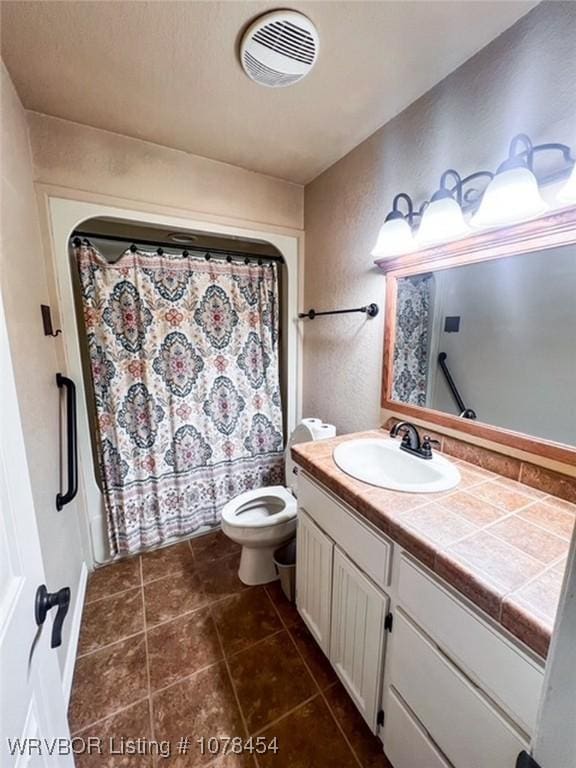 bathroom with toilet and vanity