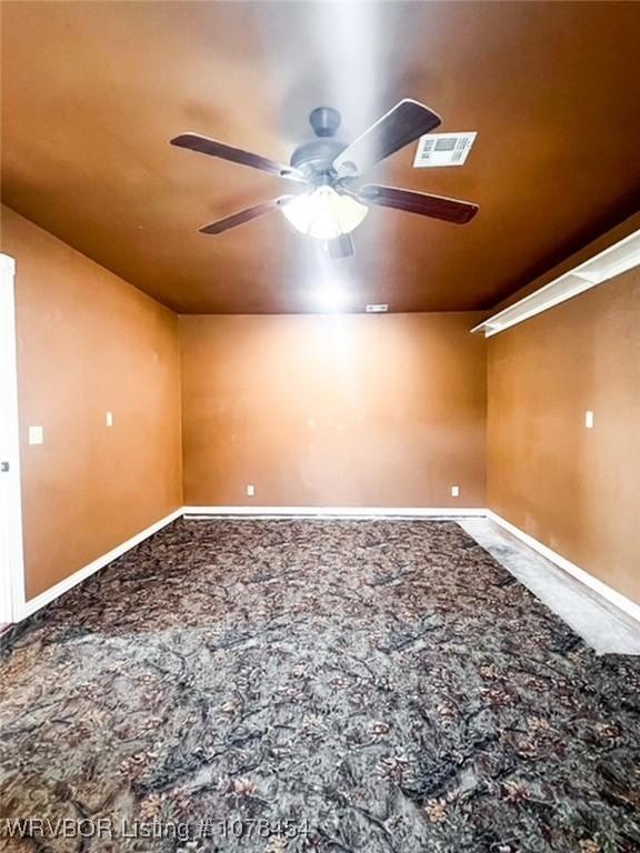 spare room with ceiling fan and carpet floors