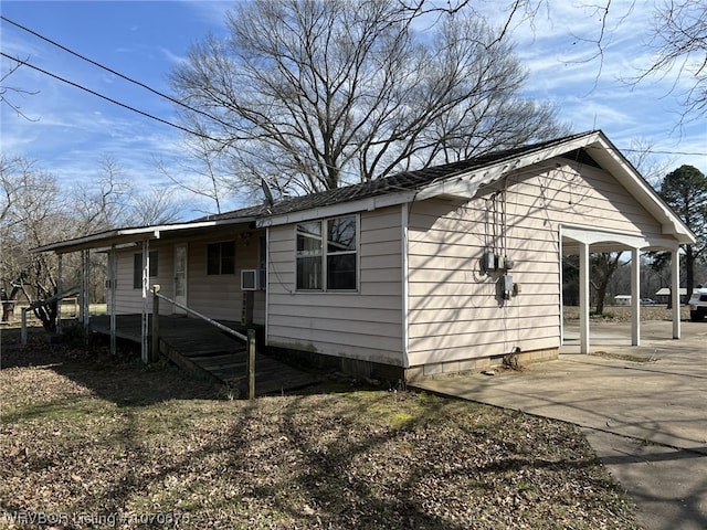 view of side of home with a carport