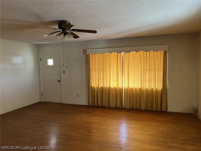 interior space featuring hardwood / wood-style flooring, ceiling fan, and a textured ceiling