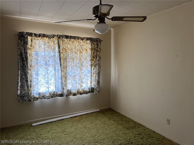 carpeted spare room with ceiling fan, ornamental molding, and a baseboard heating unit