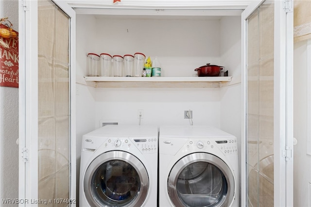 clothes washing area featuring washer and clothes dryer