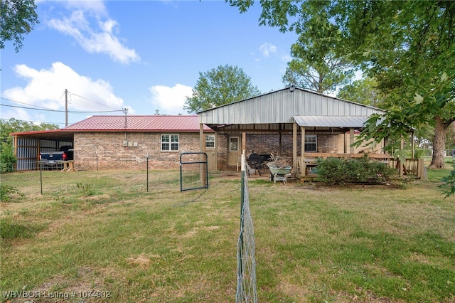 rear view of house with a yard