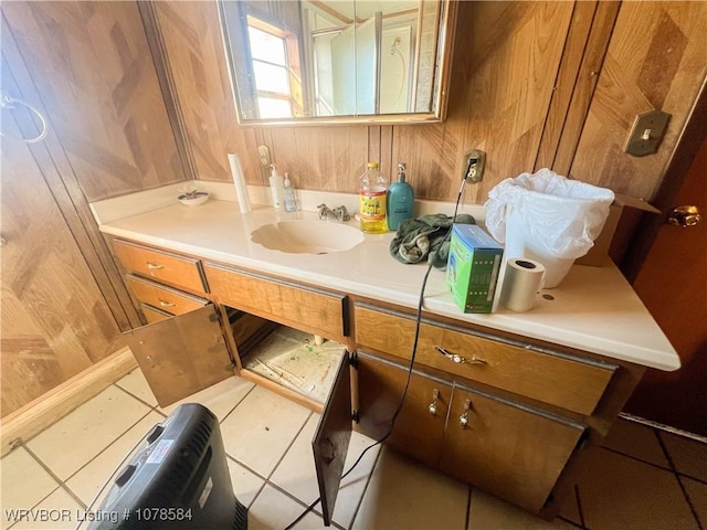 bathroom featuring tile patterned floors, wooden walls, and vanity