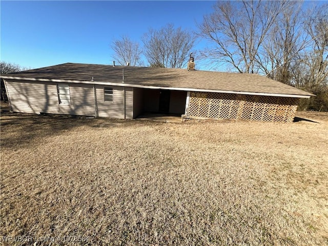 back of property featuring a lawn