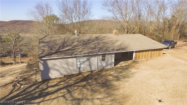 view of side of home with a mountain view