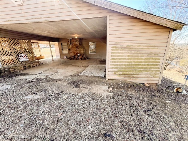 view of side of home with a carport