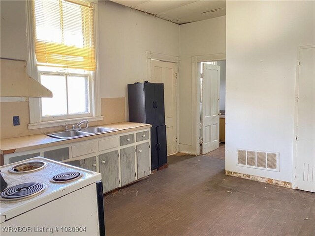 300 17th St, Fort Smith, AR 72901 - kitchen featuring white electric stove, a sink, wood finished floors, light countertops, and freestanding refrigerator