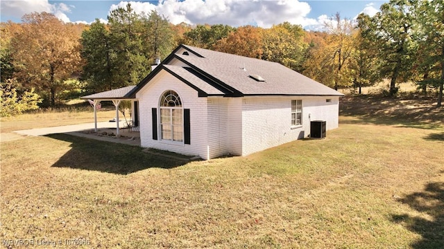 view of home's exterior featuring central AC and a lawn