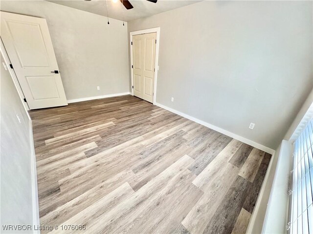 unfurnished bedroom featuring ceiling fan and light wood-type flooring