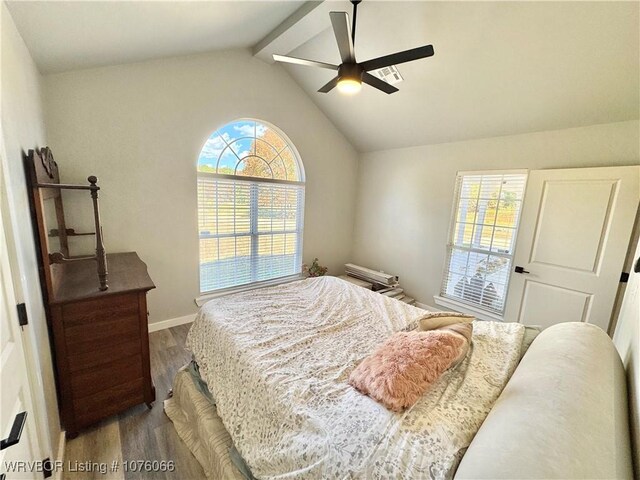 bedroom with ceiling fan, lofted ceiling with beams, and wood-type flooring