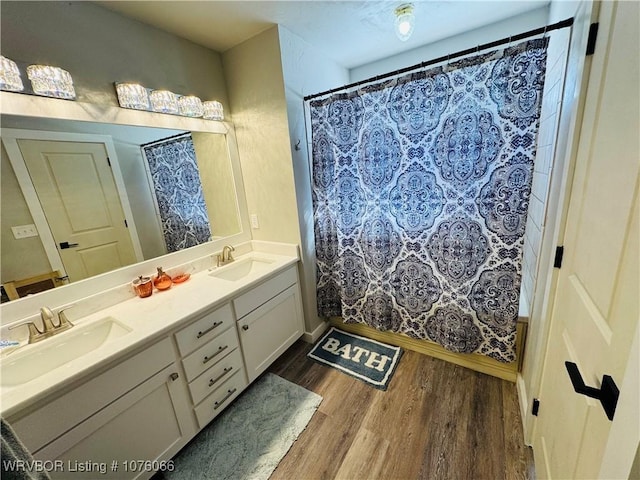 bathroom with vanity, hardwood / wood-style flooring, and walk in shower