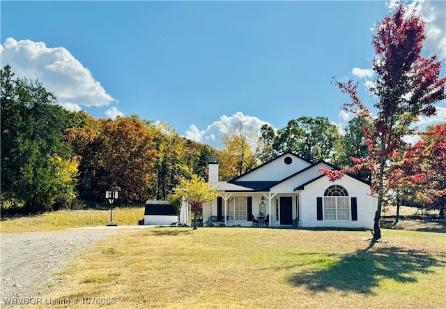 view of front of property with covered porch and a front yard