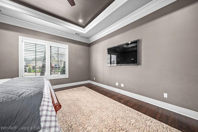 8200 Mile Tree Dr, Fort Smith, AR 72903 - bedroom featuring crown molding, dark wood-type flooring, a ceiling fan, a raised ceiling, and baseboards