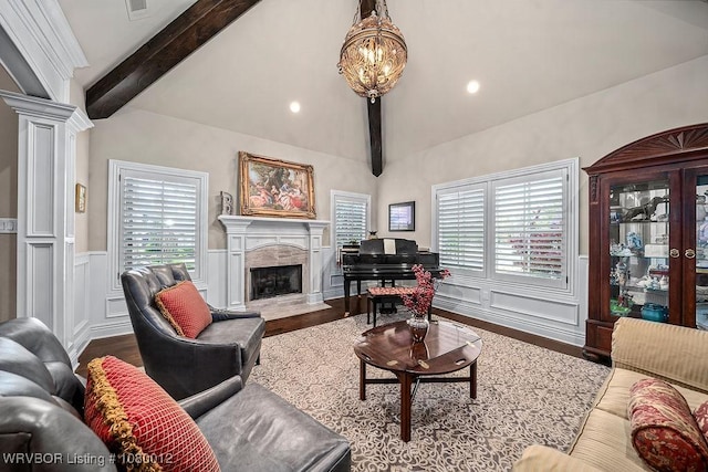 8200 Mile Tree Dr, Fort Smith, AR 72903 - living area with lofted ceiling with beams, a wainscoted wall, decorative columns, a high end fireplace, and wood finished floors