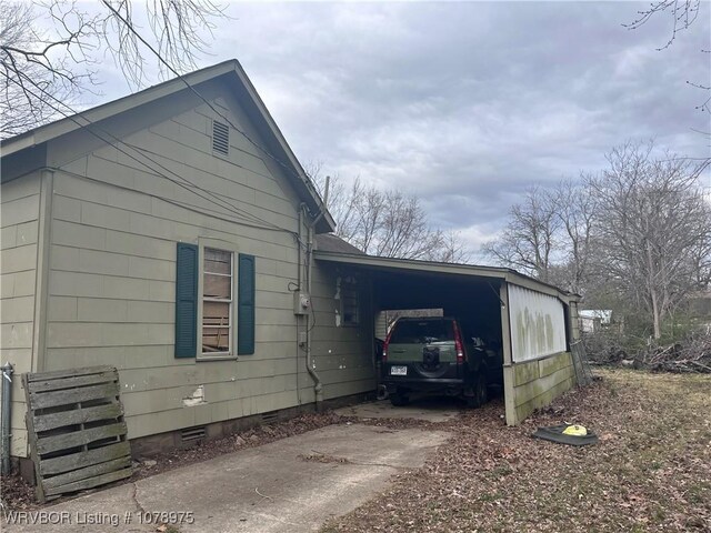 436 N Pine St, Waldron, AR 72958 - view of home's exterior featuring concrete driveway, a carport, and crawl space