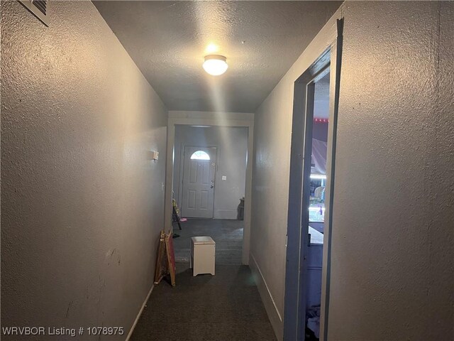436 N Pine St, Waldron, AR 72958 - entryway featuring a textured ceiling, a textured wall, carpet flooring, and baseboards