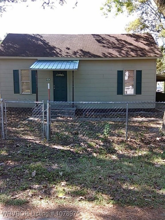 view of front of property with a fenced front yard and a gate