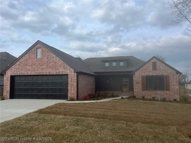 view of front facade with driveway, an attached garage, a front yard, brick siding, and a shingled roof