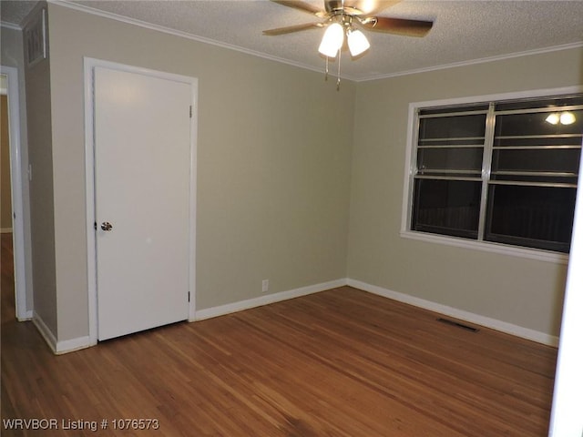 unfurnished room featuring a textured ceiling, hardwood / wood-style flooring, ceiling fan, and ornamental molding