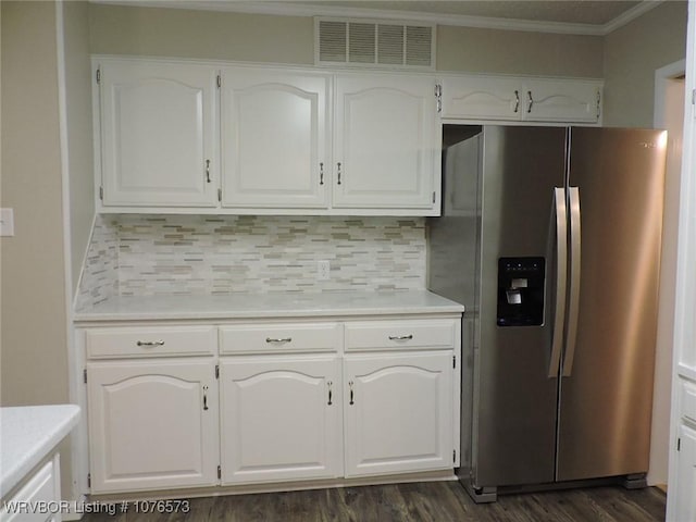 kitchen with white cabinetry, stainless steel fridge with ice dispenser, tasteful backsplash, and crown molding