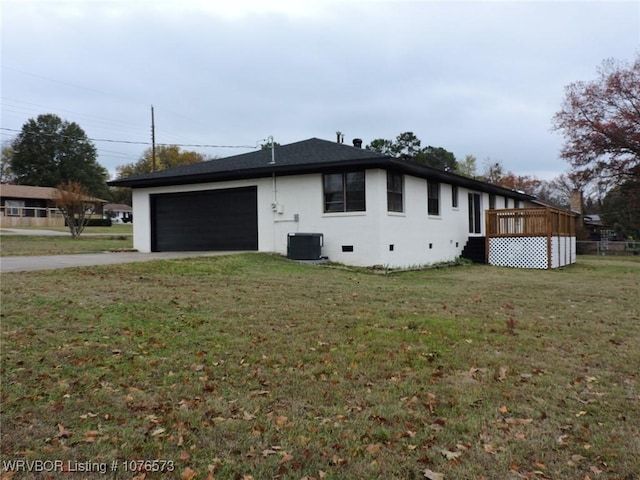 view of side of home with cooling unit, a garage, a yard, and a wooden deck