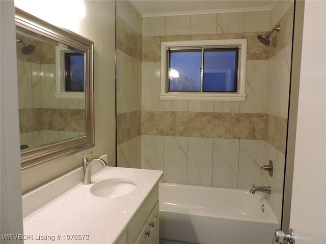 bathroom with vanity, crown molding, and tiled shower / bath combo