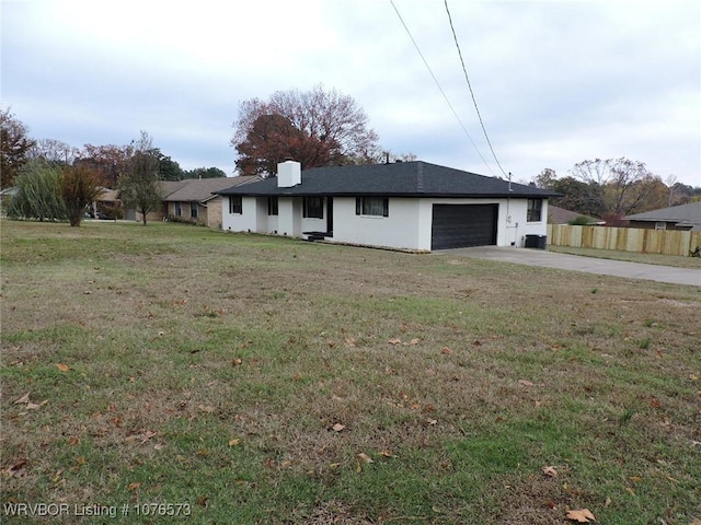 exterior space with a garage and a front lawn