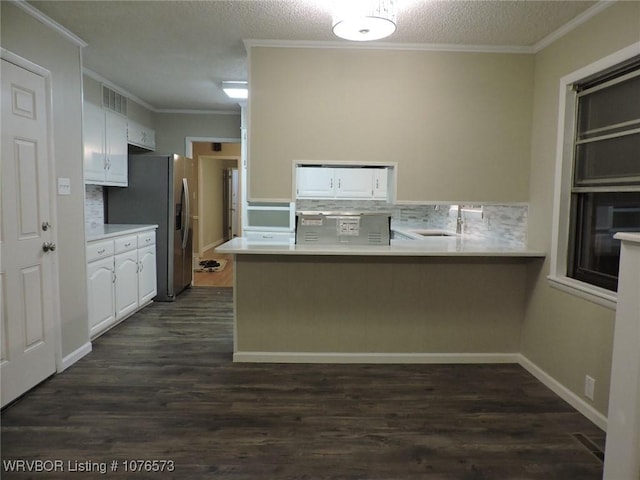 kitchen with white cabinetry, sink, dark wood-type flooring, backsplash, and kitchen peninsula